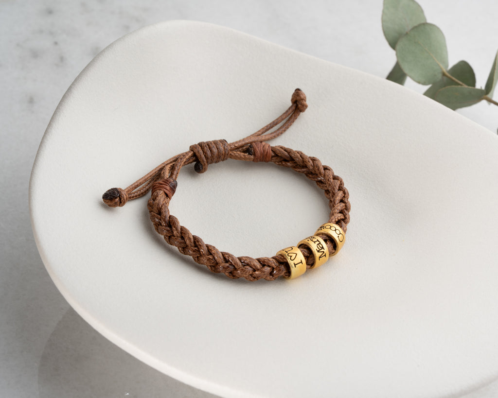 Women's hand-braided bracelet with personalized charms, crafted in the Artizian studio