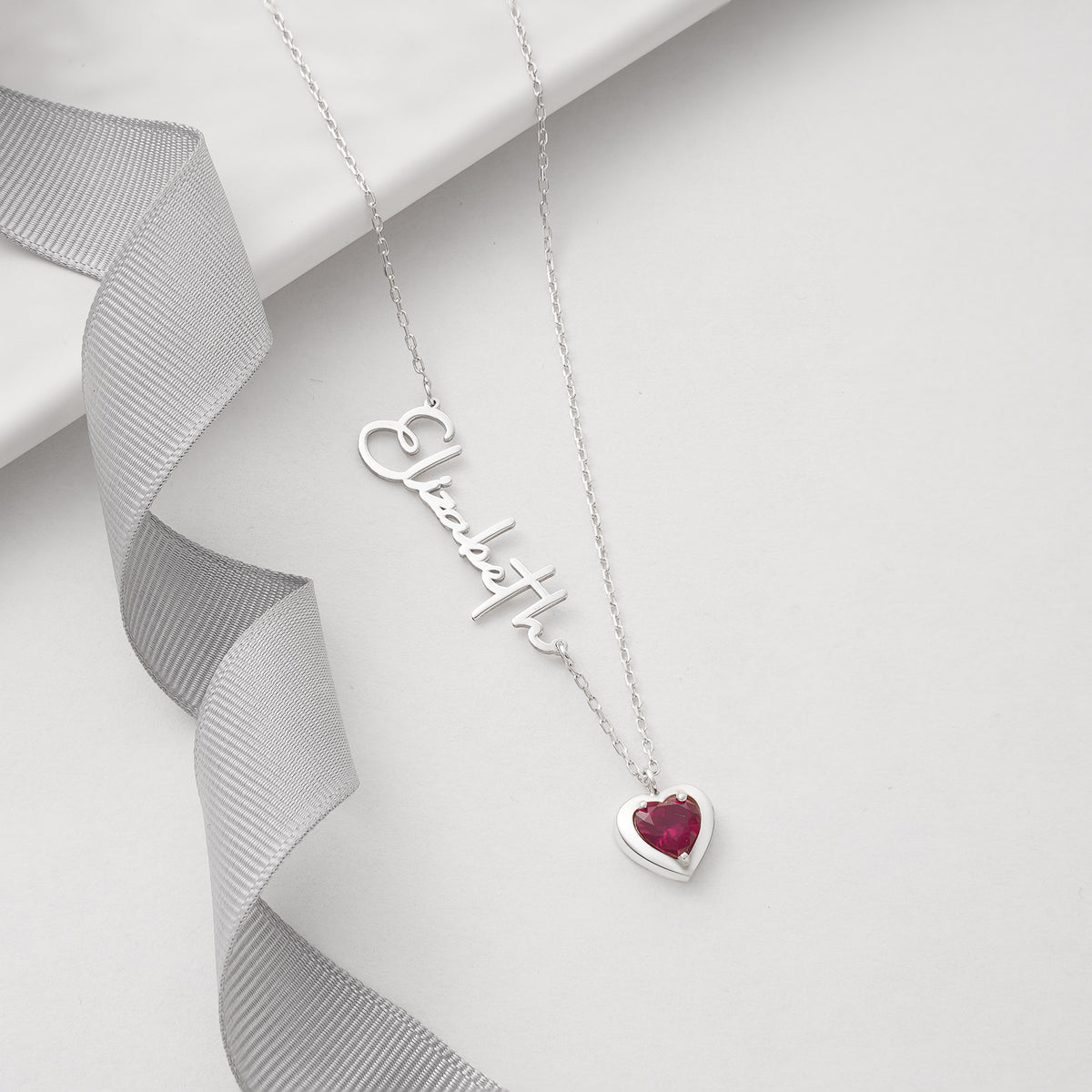 Name necklace with heart birthstone charm, crafted in the Artizian studio
