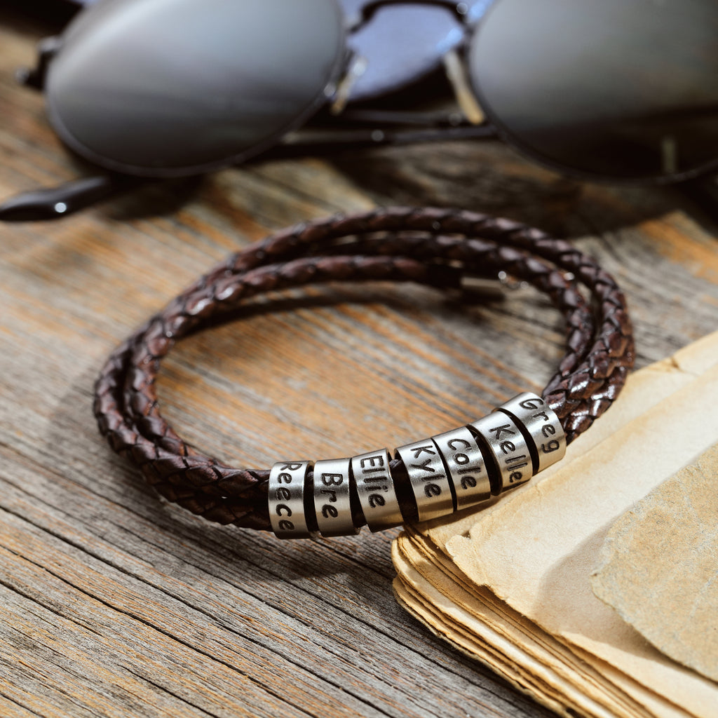 Men's leather wrap bracelet with personalized engraved beads, crafted in the Artizian studio