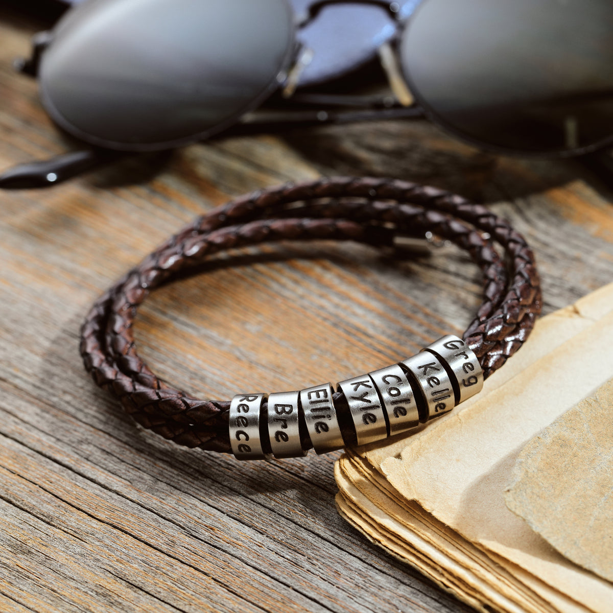Men's leather wrap bracelet with personalized engraved beads, crafted in the Artizian studio