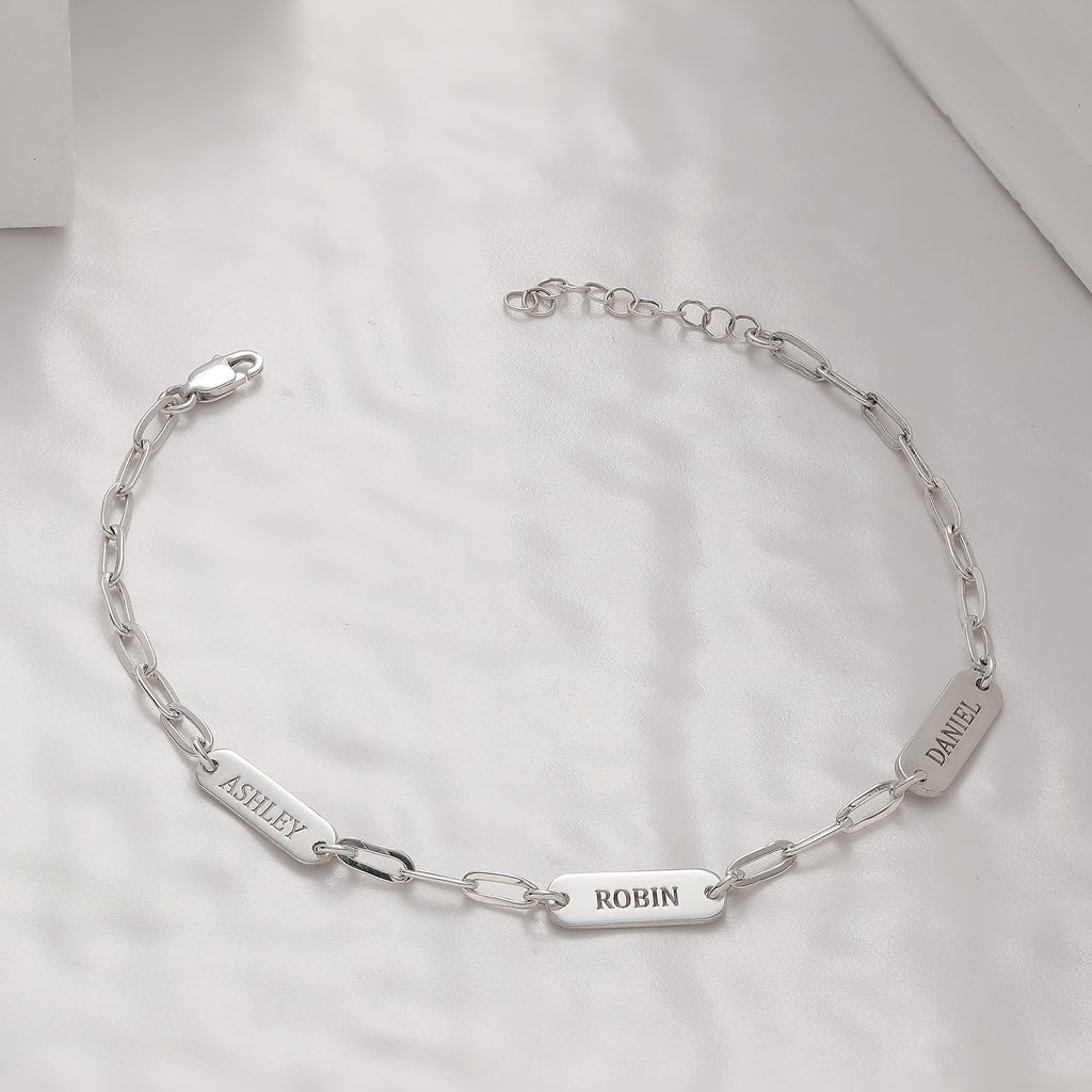 Paperclip chain bracelet with personalized engraved charms, crafted in the Artizian studio